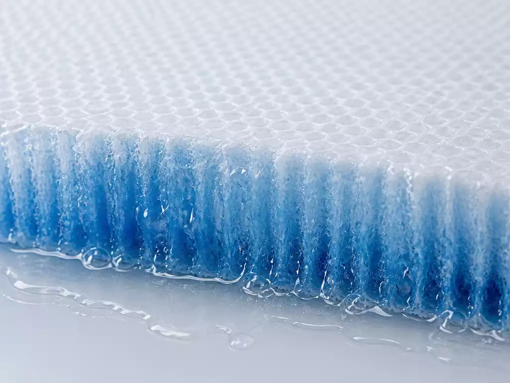 Close-up of a humidifier pad absorbing water, showing its porous texture and moisture wicking