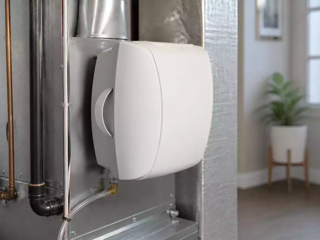 Modern furnace humidifier installed in a home's HVAC system, clean and well-maintained