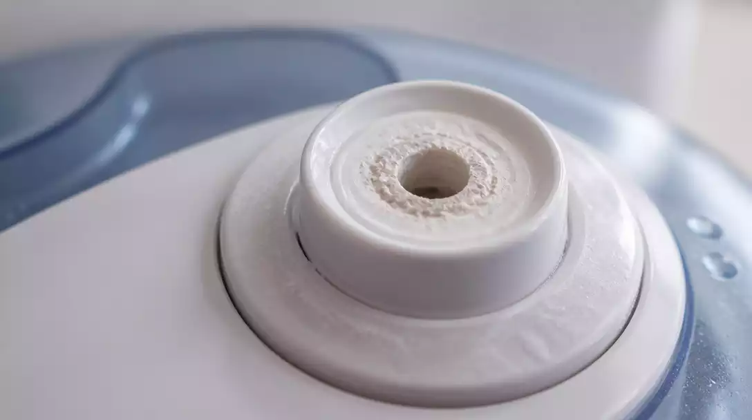 Close-up of a humidifier nozzle with mineral buildup