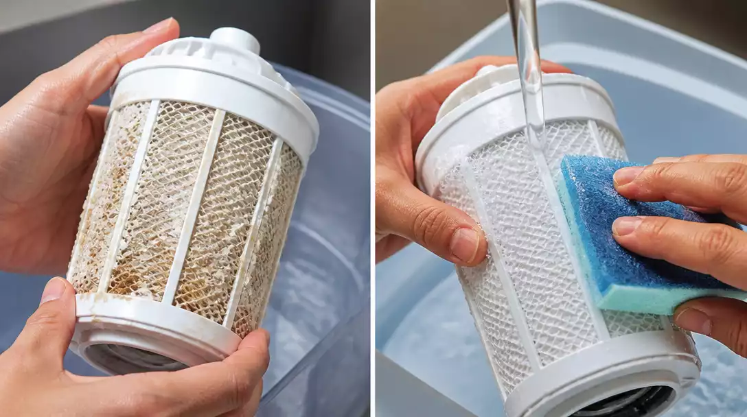 Close-up of a Walgreens humidifier filter being cleaned, showing mineral buildup and the cleaning process. Focus on hands and filter.