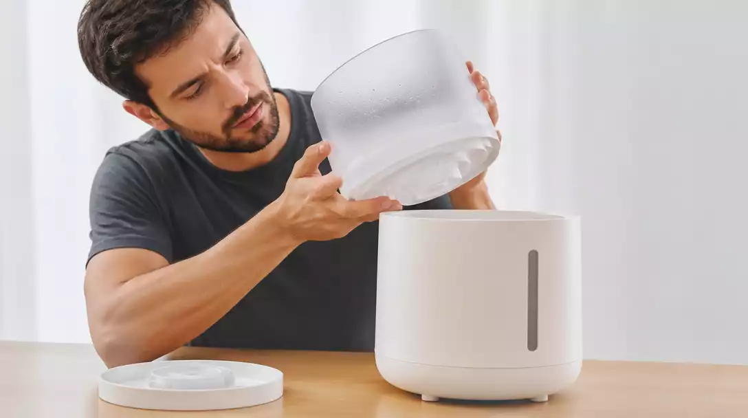 Person inspecting a HuPro Humidifier's water tank for leaks